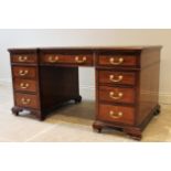 A 19th century mahogany and satinwood crossbanded inverted break-front pedestal desk, inset with a