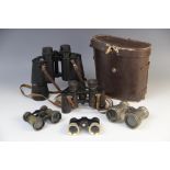 Three pairs of opera glasses including a mother of pearl banded example, a pair of military issue