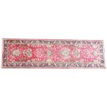 A vintage multi coloured ground Persian Tabriz runner floral design, the central red ground within a