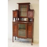 An Edwardian inlaid mahogany display cabinet, the architectural high back formed with a central