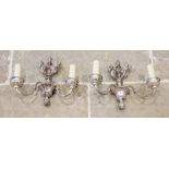 A pair of chromed metal twin branch wall light sconces, early 20th century, each with a fruit finial