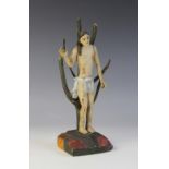 LATIN AMERICAN FOLK ART: A carved and painted model of Saint Sebastian, modelled on a rocky ground