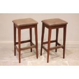 A pair of mid century Gordon Russell teak bar stools, the later re covered upholstered seats