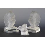 A Lalique opalescent glass figure of a seated cherub, signed Lalique to base, 8cm high, together