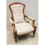 A Victorian walnut open armchair, the shaped button back extending to padded out swept arms with