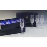 A cased set of twelve Bohemia crystal champagne flutes, each with cut glass bodies, within three