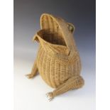 A novelty waste paper basket in the form of a frog, mid 20th century, modelled with woven rattan,