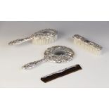 A four-piece silver backed dressing table set, W I Broadway & Co, Birmingham 1983, comprising hand