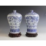 A pair of Chinese porcelain blue and white Meiping vases, Yongzheng mark, each printed with