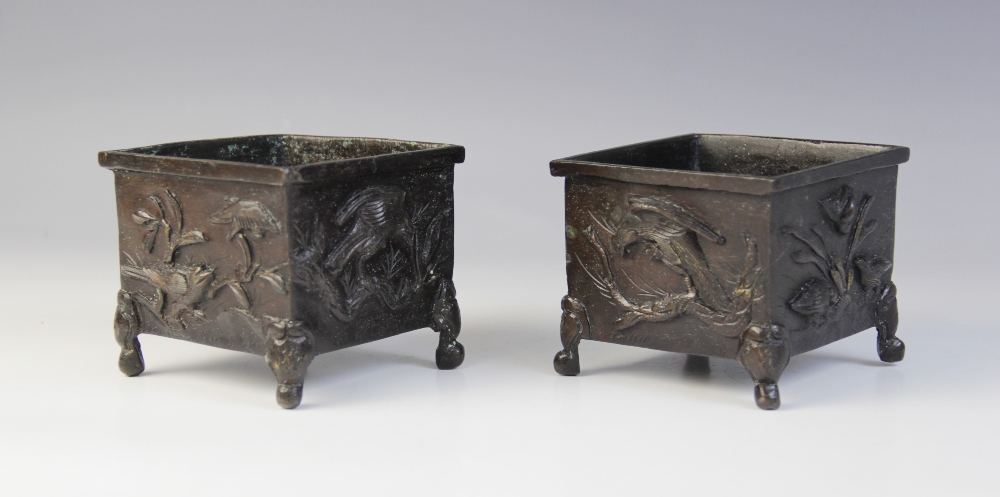 A pair of Japanese bronze cache pots, Meiji period (1868-1912), each of square form and relief
