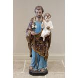 A plaster figural group of large proportions, 19th century, modelled as Saint Joseph holding the