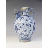 An 18th century Italian faience jug, possible Ligurian, of bulbous form with strap handle, decorated