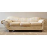 An Empire style padded scroll end day bed, in cream coloured fabric,