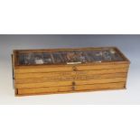 An oak haberdasher's table top display cabinet, early 20th century, comprising four sectioned