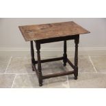 An 18th century oak side table, the rectangular moulded two plank top raised upon ring turned and