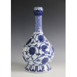 A Chinese porcelain blue and white bottle vase, Jiajing mark, decorated with formal scrolling sprays