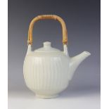 David Leach (1911-2005), a porcelain teapot with fluted cut-sided detail, celadon glaze and cane