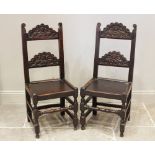 A near pair of late 17th century oak Derbyshire side chairs, each chair with carved scroll terminals