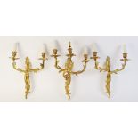 Three Rococo style wall sconces, each of foliate form, one with three branches and a pair with