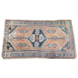 A Anatolia Yahyali type rug, woven in blue and red dyes with a central amulet within an open