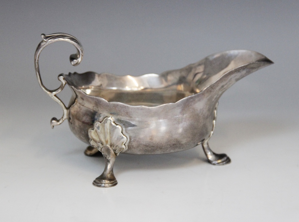 A George II silver sauce boat, Isaac Cookson, Newcastle 1752, of typical form with scalloped border,