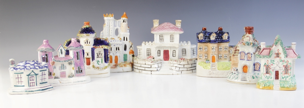 A collection of nine Staffordshire cottages, 19th century, to include two money boxes, a