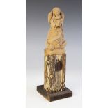 LATIN AMERICAN FOLK ART: A painted terracotta sculpture modelled as the Virgin Mary standing at