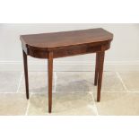 A George III mahogany folding tea table, the shaped top with inlaid satinwood stringing to the edge,