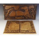 A stained wooden panel naturalistically carved with a lioness and her cubs, 29.5cm x 61cm, with a