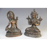 Two Indian copper Bodhisattva, each modelled seated on a lotus crown base, 16.5cm and 18cm high (2)