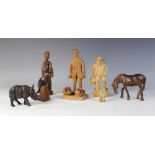 LATIN AMERICAN FOLK ART: Three carved wooden figures, modelled as a fruit seller, 19.5cm high, an