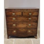 An early 19th century mahogany chest of drawers, the rectangular crossbanded top above an