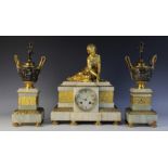 A late 19th century French onyx and gilt metal Egyptian revival clock garniture, the breakfront case