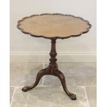 A George III mahogany tray top tripod table, the scalloped table top mounted upon a birdcage