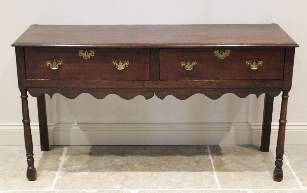 A George III and later oak dresser, the rectangular moulded top above a pair of cross banded