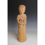 LATIN AMERICAN FOLK ART: A terracotta figure, probably Brazilian, modelled as a woman in a floral