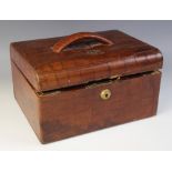 An Edwardian crocodile leather jewellery box, of hinged rectangular form opening to reveal and green