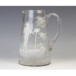 A glass water jug, 19th century, of conical form, decorated in the manner of Mary Gregory with a boy