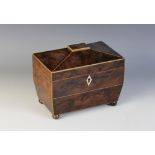 A George III yew wood tea caddy, of sarcophagus form, opening to twin lidded compartments, raised