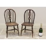 A pair of child's elm seated wheel back kitchen chairs, mid 20th century, each with an arched back