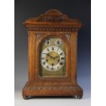 A Victorian oak cased bracket clock, the architectural carved case enclosing a 14cm arched gilt