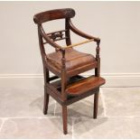 A George IV mahogany child?s highchair, with correction bar, the concave top rail with carved