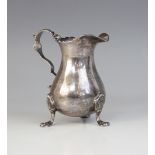 A George II silver milk jug, possibly John Kirkup, Newcastle 1748, of baluster form with shaped rim,