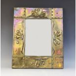 An Arts & Crafts brass framed wall mirror, early 20th century, the frame constructed from overlaid
