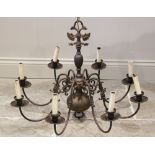 An early 20th century brass Dutch style eight branch light fitting, the central bulbous column