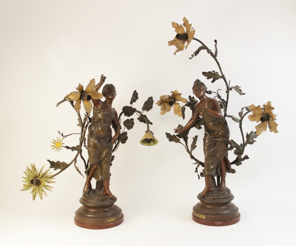 A pair of French Art Nouveau spelter figural table lamps, titled 'Muse des Bois' and 'Chant des