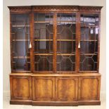 A George III style breakfront mahogany library bookcase, late 20th century, the dentil and arcaded