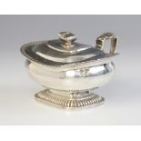 A George III silver wet mustard pot, London 1813 (maker's mark worn), of squat form on raised reeded