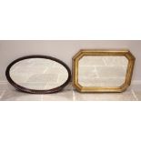 An oval wall mirror, the bevelled mirrored plate within a gadrooned hardwood frame, 59cm x 94cm,