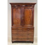 A 19th century mahogany linen press, the cavetto cornice above a pair of invert panelled cupboard